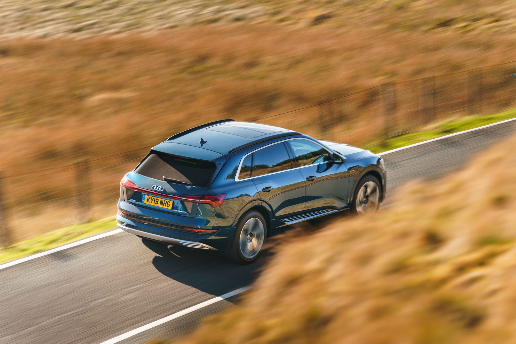 overhead view of an audi e tron driving on a road